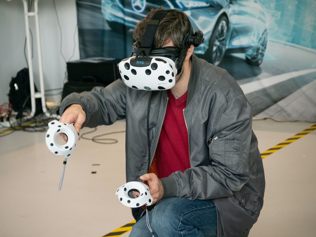 A man wearing a vr headset with polka dots on it.