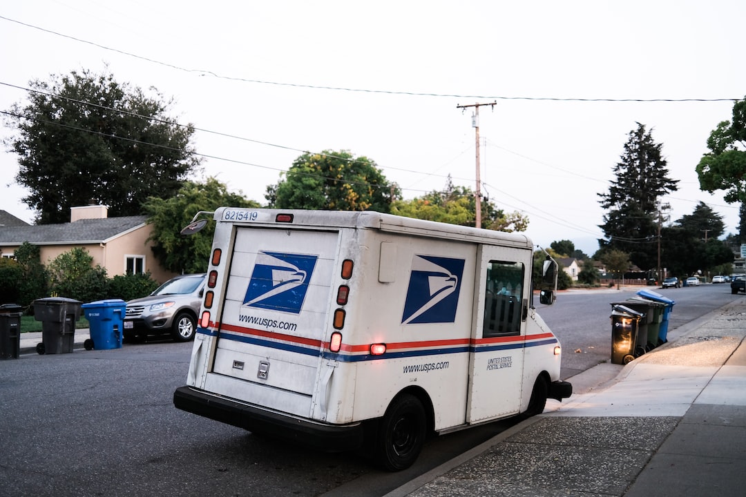 A us postal truck parked on the side of a street.