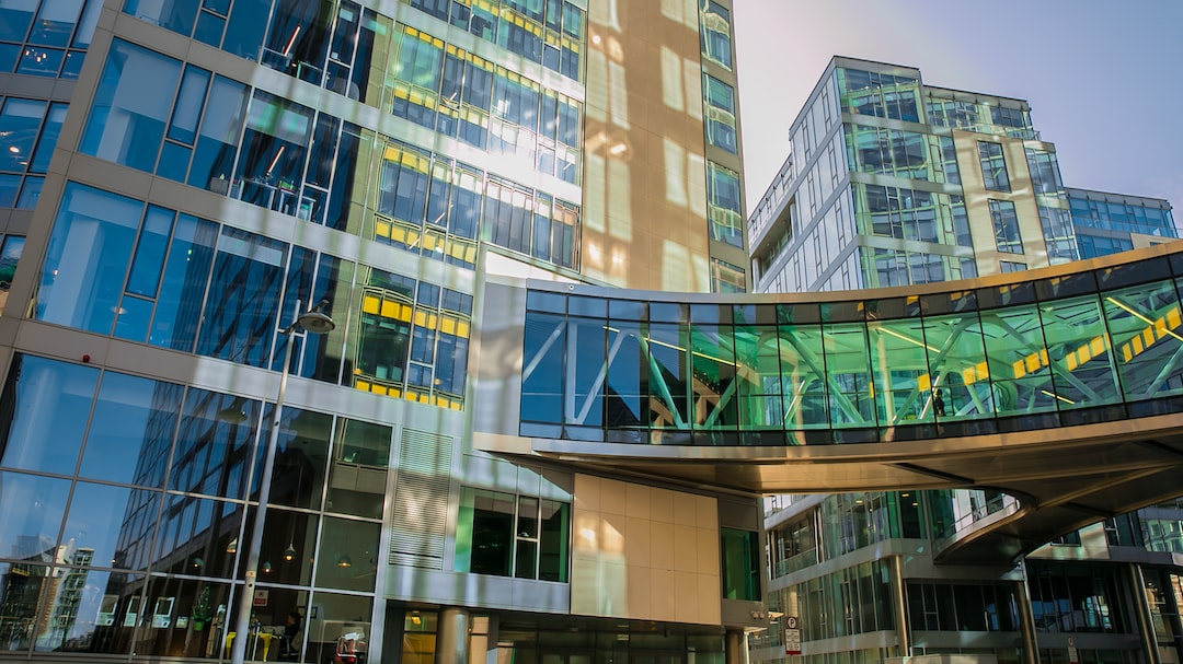 An image of a building with a green glass facade.