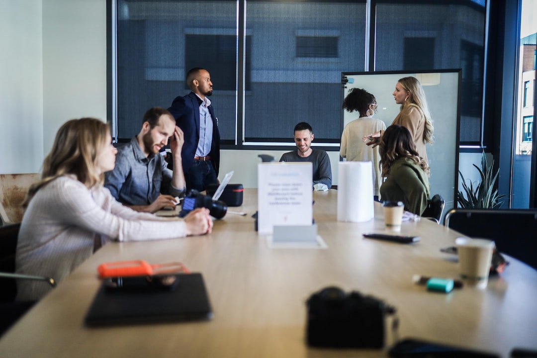 A group of people sitting around a table in a conference room.