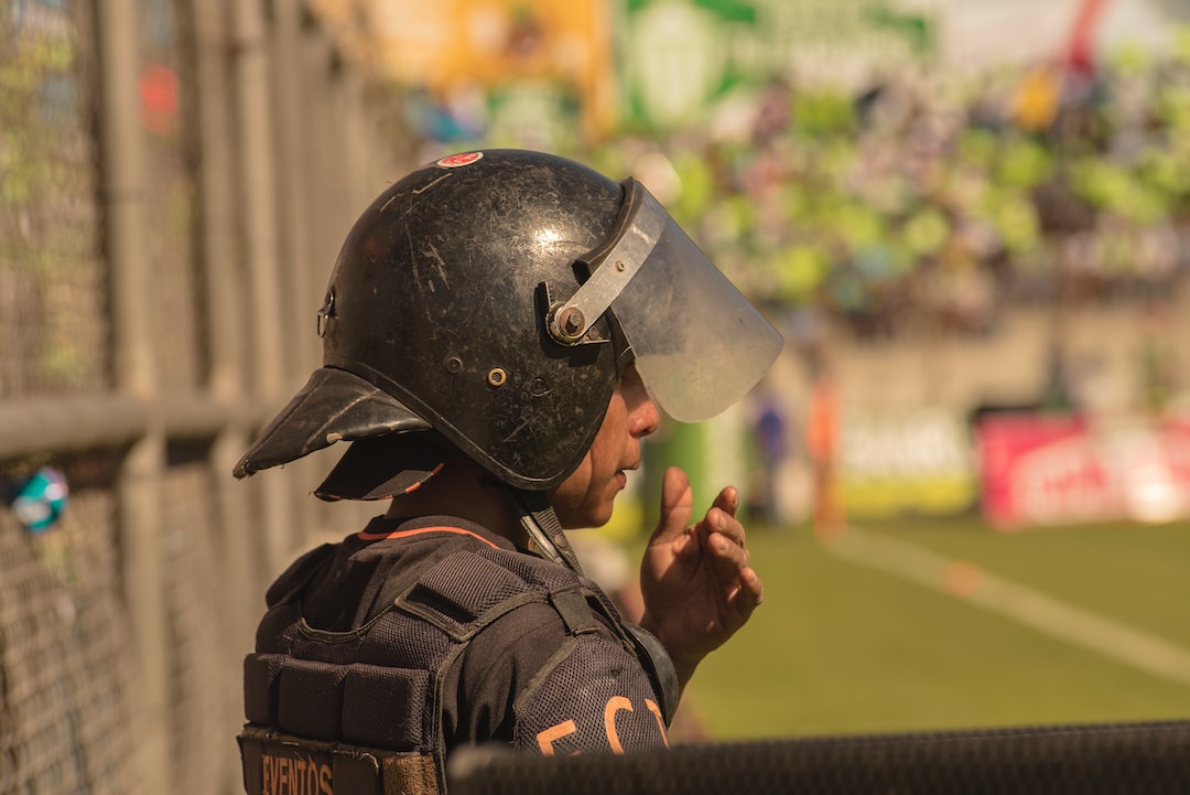 A police officer wearing a helmet at a soccer game.