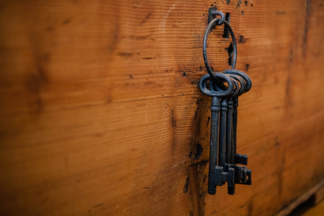 A set of keys hanging on a wooden door.