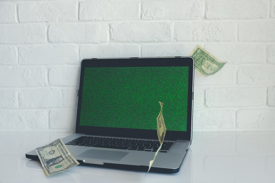 A laptop computer with money flying out of it.