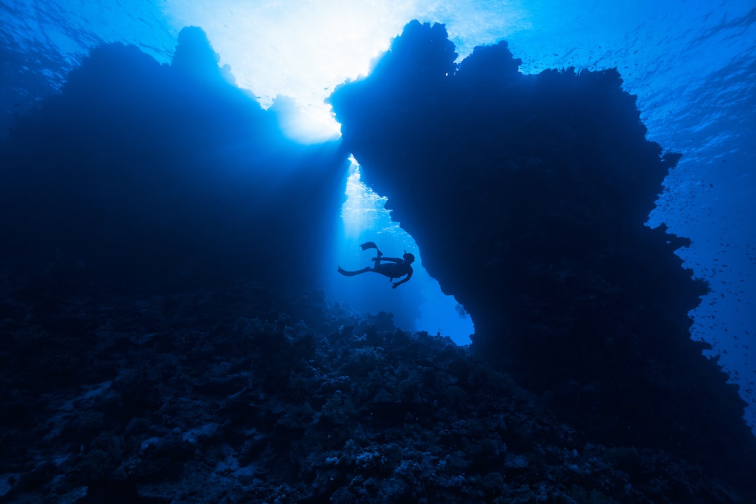 A scuba diver swims through a cave.